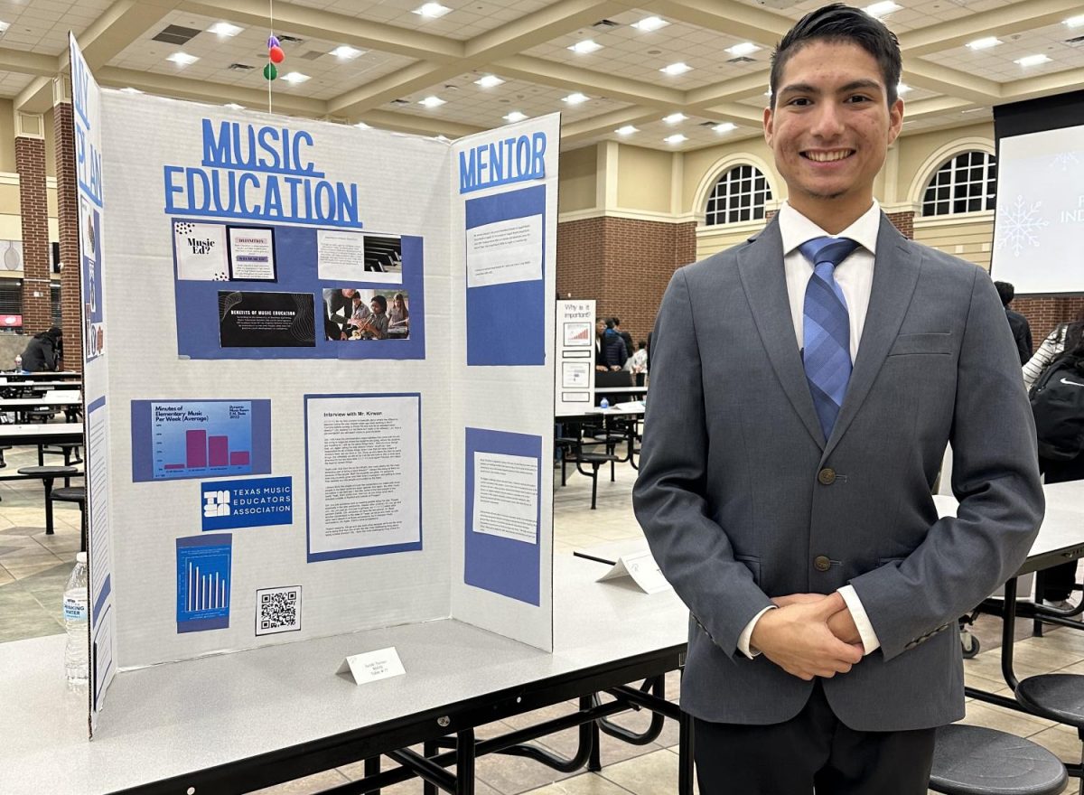Senior Jacob Turner stands next to his poster board while at the Prosper Career Independent Study programs winter showcase. While in PCIS, he wants to research Music Education and become a future music educator. 