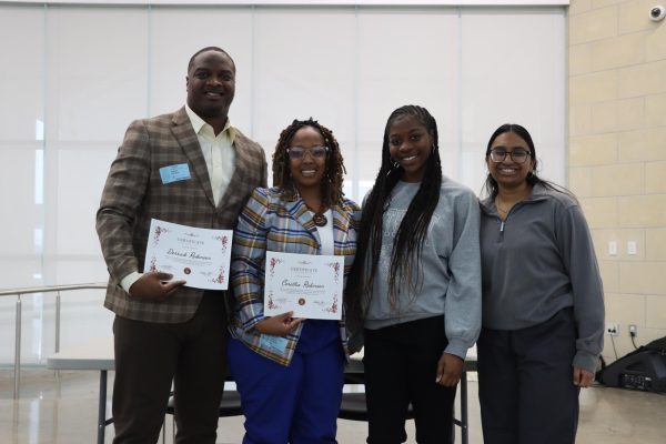 Panel Members Mr. Derrick Robinson and Mrs. Ceretha Robinson standing next to Black Student Union President Rayna Martin and Psi Alpha President Jaya Ande after discussing mental health during a combined panel meeting. “We will mostly be talking about the couples experience in a relationship and how the feeling of love helps their everyday like experiences, even in mental health,” Psi Alpha President Senior Jaya Ande said. 
