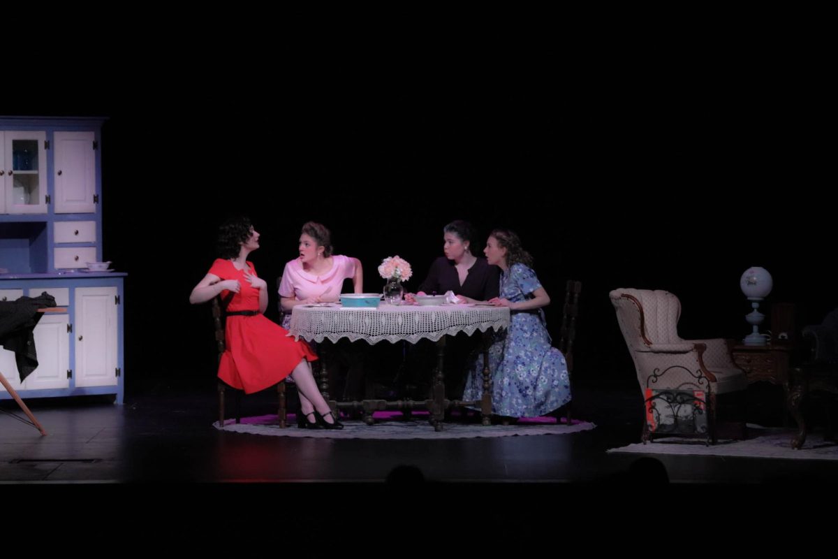 While gossiping around the kitchen dining table, the three wives and Aunt Ola engage in a discussion regarding the men involved in the war. “Ola has a dry sense of humor that can lighten up the show at times and then when she deepens up its heartbreaking,” junior casted as Aunt Ola Mackenzie Flowers said. “I feel like a lot of older women in the audience can relate to Ola in every sense of her character.” The character, Aunt Ola, showed the importance of her role throughout the play. 