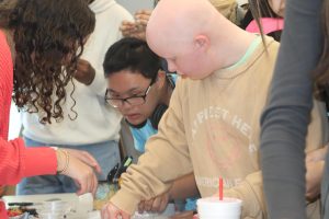 Freshman Macey Hunt and junior Jon Brian participate in the Hope Squad friendship-bracelet making at lunch. “There are many lunch activities that Hope Squad is managing.” Figueroa-Jones said.