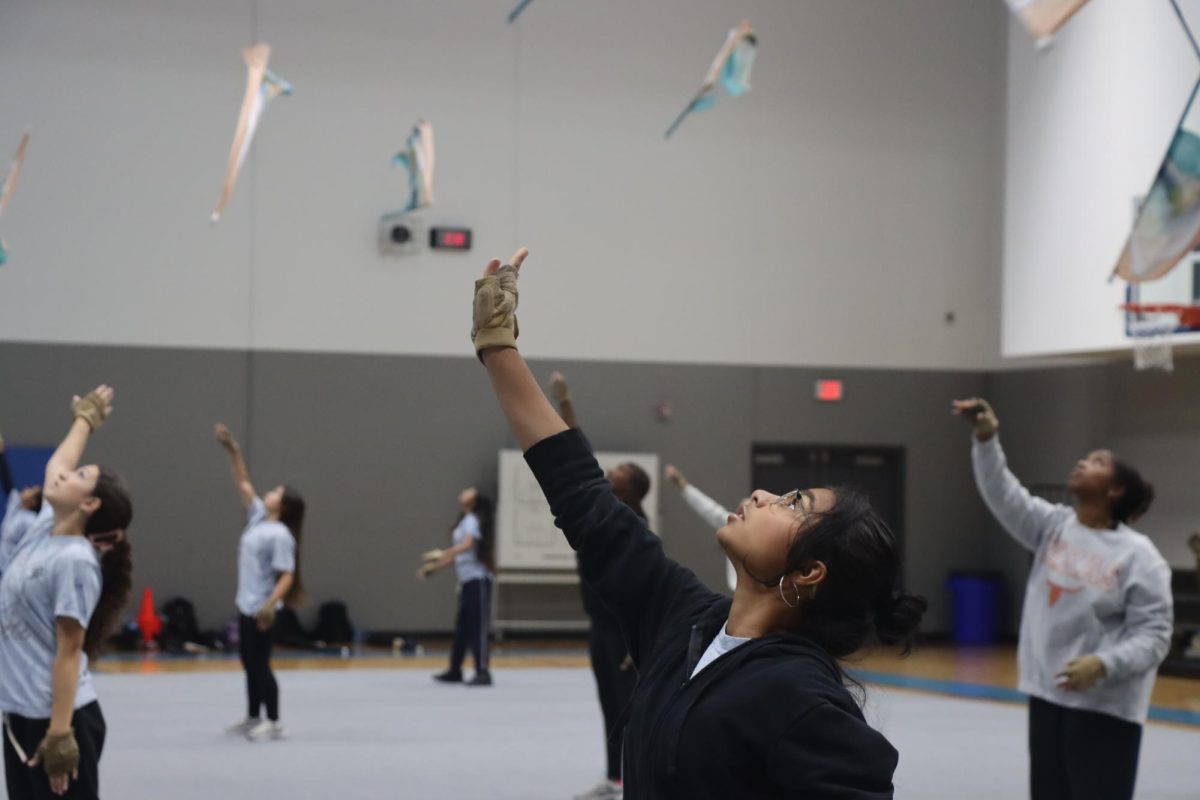 Junior Akanksha Agrawal spots her flag as everyone throws in sync.