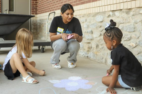 Sophomore Aparna Uppalapati crouches between two girls, engaging with them as they create a chalk flower on the pavement. “I love children and I’m very passionate about children, so that’s why I joined TAFE,” Uppalapati said. “After being in TAFE,  I learned how to get a child to understand [me] better and how to understand a child better.”