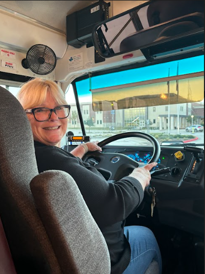 Bus Driver Sue Maurin shown smiling after a day of transporting students and spreading positvity