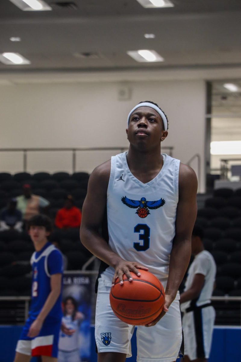 Senior Dextan Hutchinson holds a basketball, eyes locked on the hoop as he prepares to shoot. “I was trying to win for my team so that we could hopefully make playoffs and set an example for the younger teammates,” Hutchinson said.