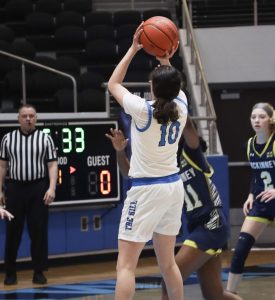Sophomore Sofia Read jumps to take a shot in a basketball game. “I use social media to show what I am capable of to coaches," Read said. "We play in a hard district so showing my accomplishments within it helps me get attention."