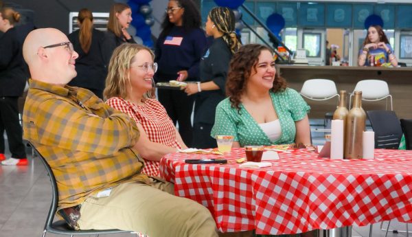 Theater directors Denton Davies, Kirsten King, and Sariea Haney smile as they watch students perform during the theater department’s dinner show, “Death by Dessert,” in the school cafeteria. “The thing I appreciate the most about our directors is that they are always there for me,” Wilson said. “I like that I am able to talk to them about anything and they always listen.”