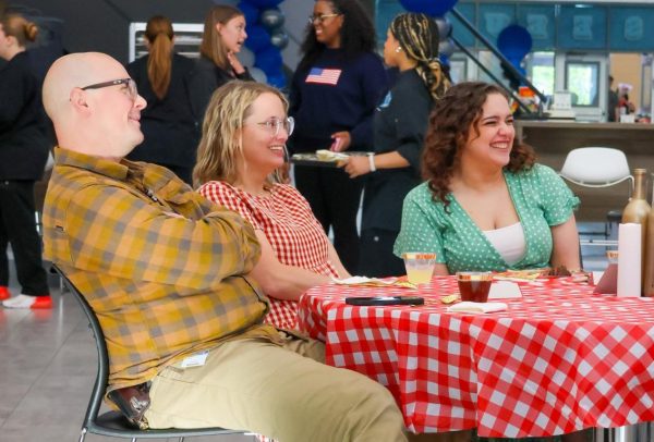 Theater directors Denton Davies, Kirsten King, and Sariea Haney smile as they watch students perform during the theater department’s dinner show, “Death by Dessert,” in the school cafeteria. “The thing I appreciate the most about our directors is that they are always there for me,” Wilson said. “I like that I am able to talk to them about anything and they always listen.”