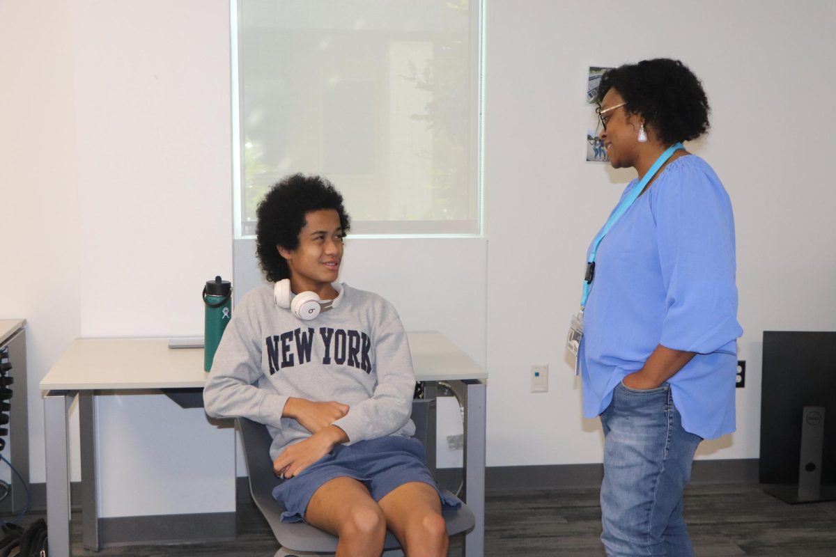 Computer Science teacher Mrs. Robertson talking to freshman Hayden London about the assignment. 