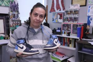In front of her desk, AP World History teacher AJ Lanier holds up a pair of blue sneakers from her extensive collection. “I value pushing kids, challenging them, making them work a little harder and then building confidence through success,” LaNier said. “I want to keep pushing them—that’s something I really enjoy, and I feel like that’s going to align really well with Richland.”
