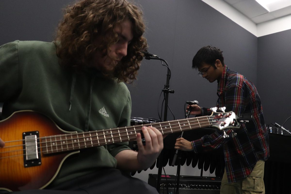 Senior bassist Jacob Sloan jams out during a practice session.
